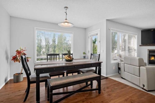 288 Evansbrooke Way Nw, Calgary, AB - Indoor Photo Showing Dining Room With Fireplace