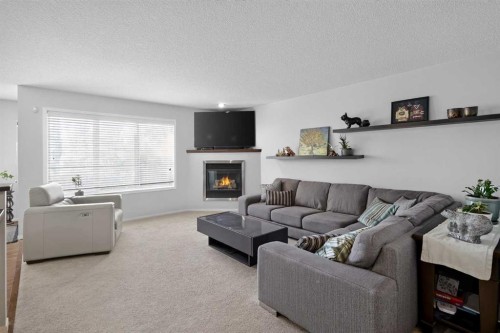 288 Evansbrooke Way Nw, Calgary, AB - Indoor Photo Showing Living Room With Fireplace