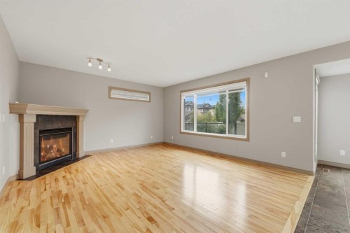 137 Evanscove Circle Nw, Calgary, AB - Indoor Photo Showing Other Room With Fireplace