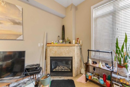 3113-24 Hemlock Crescent Sw, Calgary, AB - Indoor Photo Showing Living Room With Fireplace