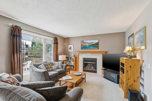 124 Schubert Hill Nw, Calgary, AB - Indoor Photo Showing Living Room With Fireplace