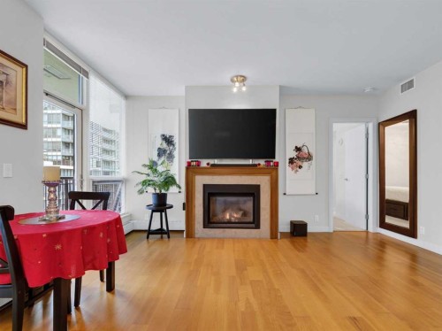511-222 Riverfront Avenue Sw, Calgary, AB - Indoor Photo Showing Living Room With Fireplace