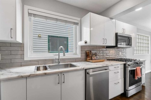 2031 2 Avenue Nw, Calgary, AB - Indoor Photo Showing Kitchen With Stainless Steel Kitchen With Double Sink