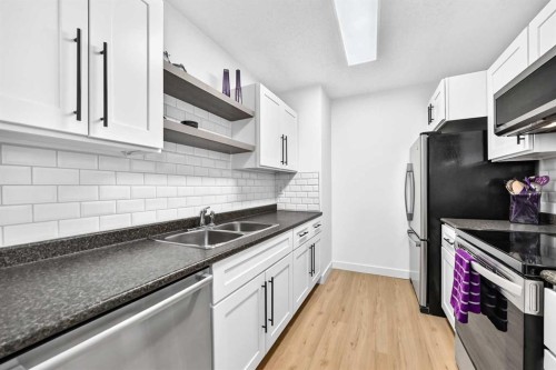 D-109 Stanley Avenue, Okotoks, AB - Indoor Photo Showing Kitchen With Double Sink With Upgraded Kitchen
