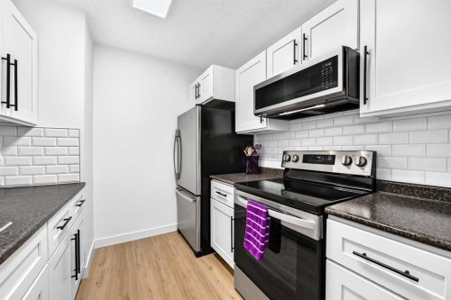 D-109 Stanley Avenue, Okotoks, AB - Indoor Photo Showing Kitchen With Upgraded Kitchen