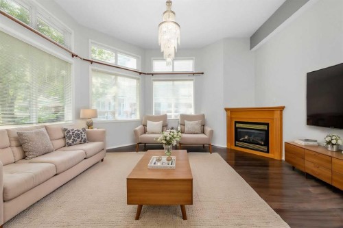 25 Prestwick Pond Terrace Se, Calgary, AB - Indoor Photo Showing Living Room With Fireplace