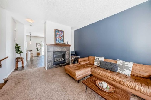 296 Sunset Point, Cochrane, AB - Indoor Photo Showing Living Room With Fireplace