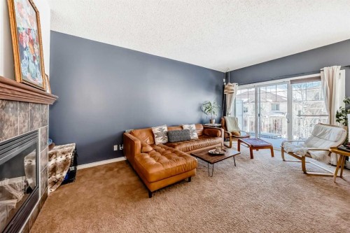 296 Sunset Point, Cochrane, AB - Indoor Photo Showing Living Room With Fireplace