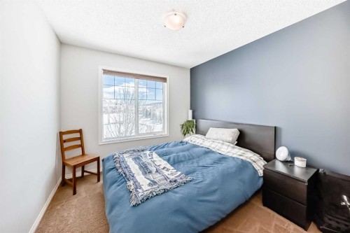 296 Sunset Point, Cochrane, AB - Indoor Photo Showing Bedroom