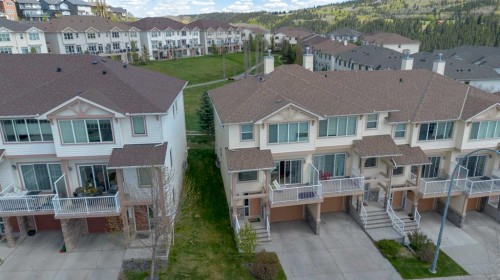 296 Sunset Point, Cochrane, AB - Outdoor With Deck Patio Veranda With Facade