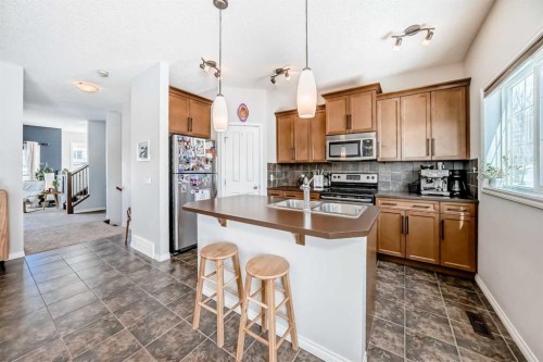 296 Sunset Point, Cochrane, AB - Indoor Photo Showing Kitchen With Double Sink