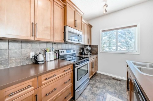296 Sunset Point, Cochrane, AB - Indoor Photo Showing Kitchen With Double Sink