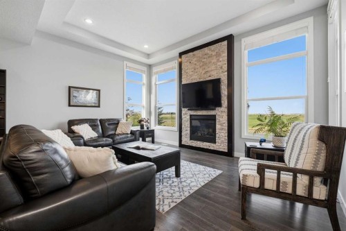 395 Boulder Creek Bay Se, Langdon, AB - Indoor Photo Showing Living Room With Fireplace