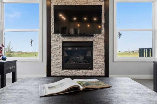 395 Boulder Creek Bay Se, Langdon, AB - Indoor Photo Showing Living Room With Fireplace