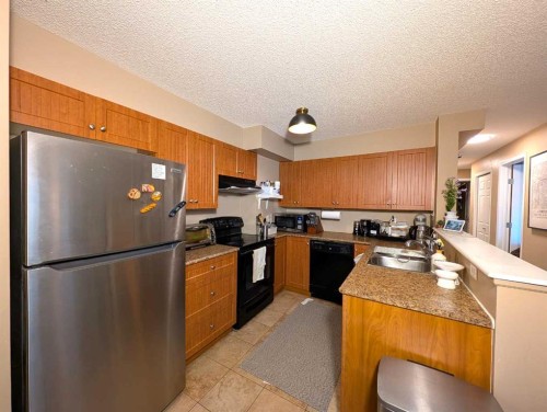 1421-8 Bridlecrest Drive Sw, Calgary, AB - Indoor Photo Showing Kitchen With Double Sink