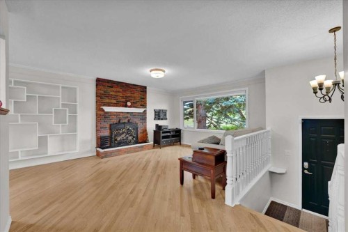 228 Nottingham Road Nw, Calgary, AB - Indoor Photo Showing Living Room With Fireplace