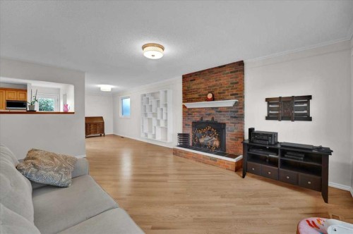228 Nottingham Road Nw, Calgary, AB - Indoor Photo Showing Living Room With Fireplace
