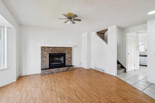 104 Falmere Way Ne, Calgary, AB - Indoor Photo Showing Living Room With Fireplace