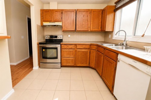 7 Dovercliffe Way Se, Calgary, AB - Indoor Photo Showing Kitchen With Double Sink