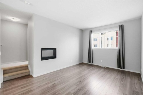 209 Copperpond Row Se, Calgary, AB - Indoor Photo Showing Other Room With Fireplace