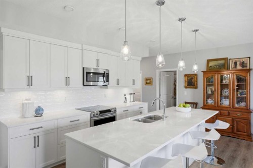 212-4150 Seton Drive Sw, Calgary, AB - Indoor Photo Showing Kitchen With Double Sink With Upgraded Kitchen