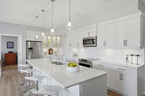 212-4150 Seton Drive Sw, Calgary, AB - Indoor Photo Showing Kitchen With Stainless Steel Kitchen With Double Sink With Upgraded Kitchen