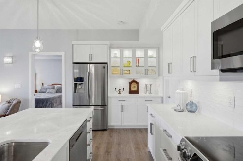 212-4150 Seton Drive Sw, Calgary, AB - Indoor Photo Showing Kitchen With Stainless Steel Kitchen With Upgraded Kitchen