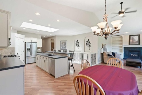 18 Panatella Terrace Nw, Calgary, AB - Indoor Photo Showing Dining Room With Fireplace