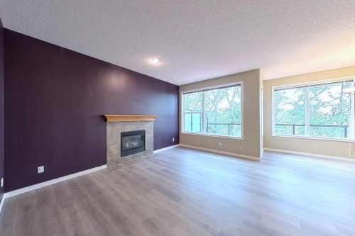 149 Rockborough Green Nw, Calgary, AB - Indoor With Fireplace