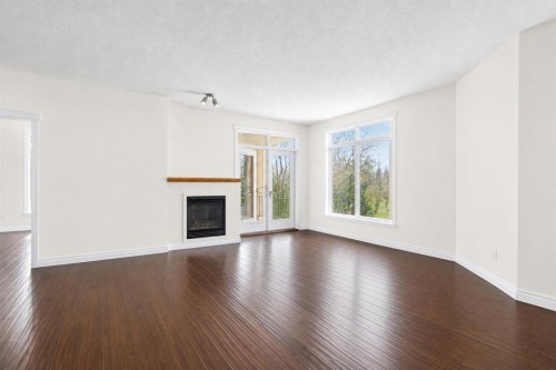 7305-14 Hemlock Crescent Sw, Calgary, AB - Indoor Photo Showing Living Room With Fireplace