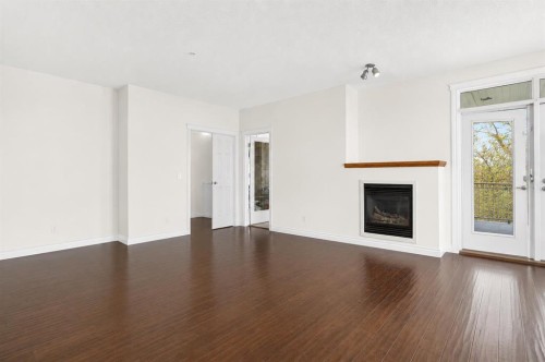 7305-14 Hemlock Crescent Sw, Calgary, AB - Indoor Photo Showing Living Room With Fireplace