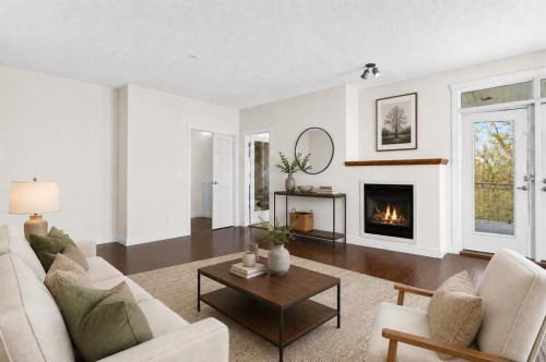 7305-14 Hemlock Crescent Sw, Calgary, AB - Indoor Photo Showing Living Room With Fireplace