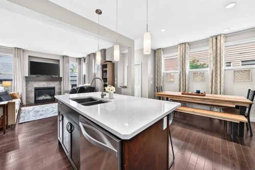 189 Chaparral Valley Drive Se, Calgary, AB - Indoor Photo Showing Kitchen With Fireplace With Double Sink