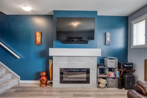 258 Copperleaf Way Se, Calgary, AB - Indoor Photo Showing Living Room With Fireplace