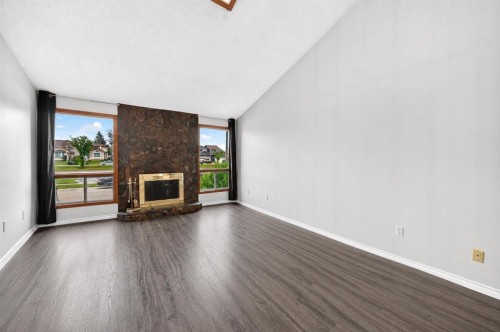 91 Castleridge Crescent Ne, Calgary, AB - Indoor Photo Showing Living Room With Fireplace