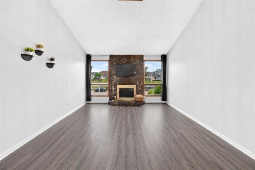 91 Castleridge Crescent Ne, Calgary, AB - Indoor Photo Showing Other Room With Fireplace