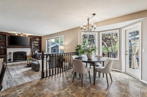 190 Mt Robson Close Se, Calgary, AB - Indoor Photo Showing Dining Room With Fireplace