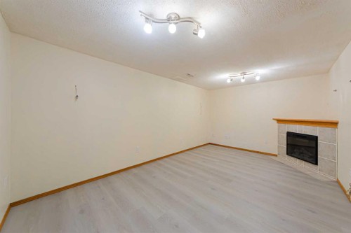 88 Country Hills Villas Nw, Calgary, AB - Indoor Photo Showing Other Room With Fireplace