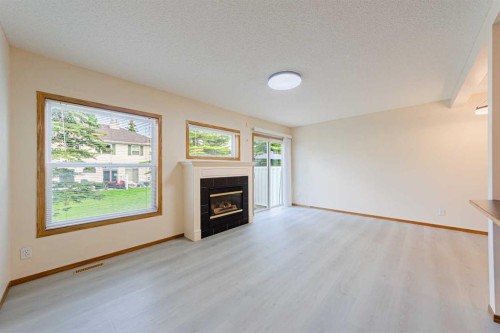 88 Country Hills Villas Nw, Calgary, AB - Indoor Photo Showing Living Room With Fireplace
