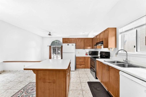 6934 Laguna Way Ne, Calgary, AB - Indoor Photo Showing Kitchen With Double Sink