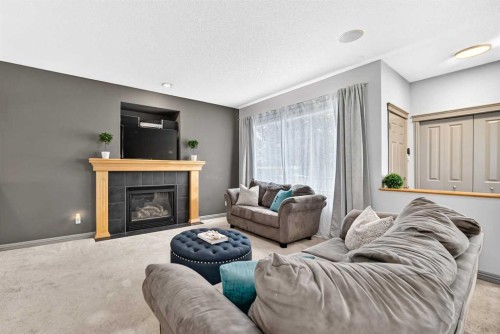 59 Prestwick Street Se, Calgary, AB - Indoor Photo Showing Living Room With Fireplace