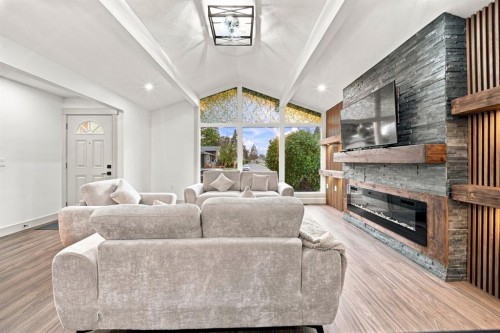 8304 11 Street Sw, Calgary, AB - Indoor Photo Showing Living Room With Fireplace