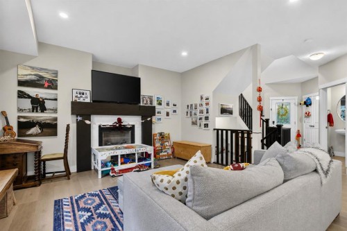 725 New Brighton Drive Se, Calgary, AB - Indoor Photo Showing Living Room With Fireplace