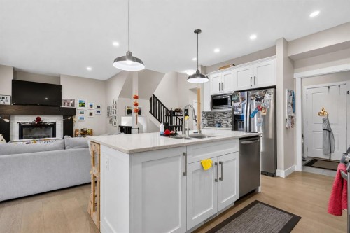 725 New Brighton Drive Se, Calgary, AB - Indoor Photo Showing Kitchen With Fireplace