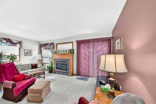 20 Everstone Place Sw, Calgary, AB - Indoor Photo Showing Living Room With Fireplace