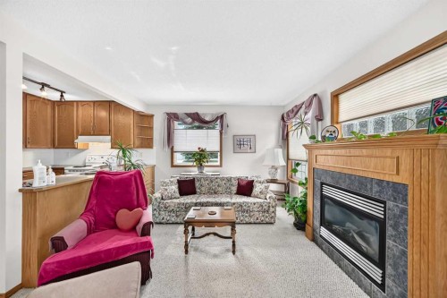 20 Everstone Place Sw, Calgary, AB - Indoor Photo Showing Living Room With Fireplace
