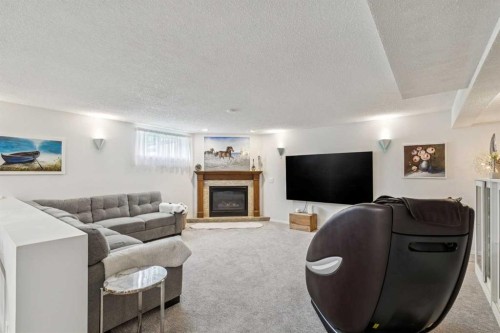 6991 Christie Briar Manor Sw, Calgary, AB - Indoor Photo Showing Living Room With Fireplace
