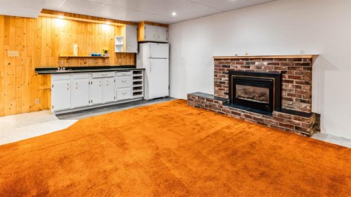 1027 Lake Sylvan Drive Se, Calgary, AB - Indoor Photo Showing Living Room With Fireplace