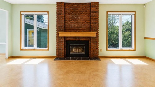 1027 Lake Sylvan Drive Se, Calgary, AB - Indoor Photo Showing Living Room With Fireplace