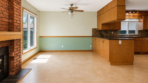 1027 Lake Sylvan Drive Se, Calgary, AB - Indoor Photo Showing Other Room With Fireplace